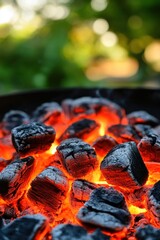 Poster - Close up of glowing charcoal embers in a barbecue grill with blurred green background and vertical composition capturing the heat and texture