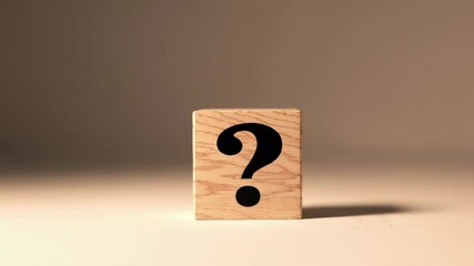 Aufkleber - Wooden cube featuring question mark resting on white surface, representing curiosity, uncertainty, and contemplative state of problem solving and decision making process