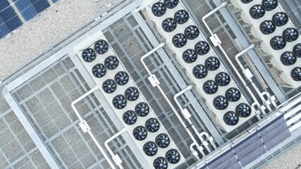 Aerial view of ventilators and HVAC systems on data center rooftop, cooling infrastructure for server operations