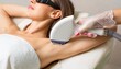 © photostockatinat - Laser hair removal, a beauty procedure performed on an armpit. The woman in the image is undergoing this procedure, and the technician is using a specialized laser to remove hair from the armpit