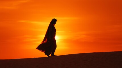 Fototapete - Artistic silhouette of an Indian woman against a glowing orange sunset on a sand dune.