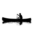 © NexusGallery - Canoeist paddles calmly a canoe on reflective water creating ripples silhouette is in solid black