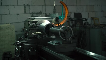 Poster - Turning metal on a lathe in a workshop during twilight hours