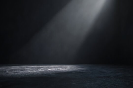 Abstract spacious place with dark wall, granular floor and spot light from above.