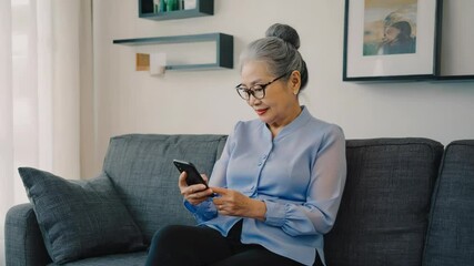 Poster - A woman sits on a couch holding her cell phone, potentially checking messages or browsing the internet.