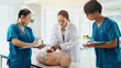 © peopleimages.com - Mannequin, students and cpr training in hospital for medical simulation exam, test or project. Healthcare, professor and group with rescue support demonstration on patient dummy at college in Japan.