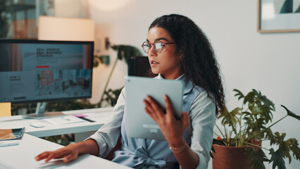 Poster - Woman, tablet and reading by computer in office for project, admin and review for proposal. Person, technology and pc for research, planning or feedback for perspective for creative agency management