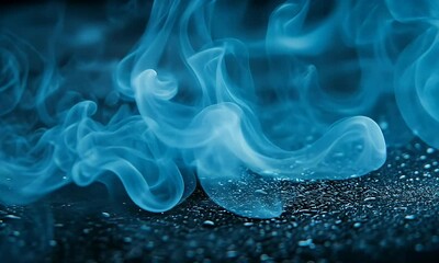 Wall Mural - Ethereal Blue Smoke Flowing Elegantly Over Dark Surface Creating Abstract Patterns and Mystical Atmosphere
