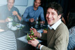 © peopleimages.com - Meeting, smile and portrait of businessman with salad in office for team building lunch for collaboration. Discussion, happy and creative designer with colleagues eating healthy meal in workplace.