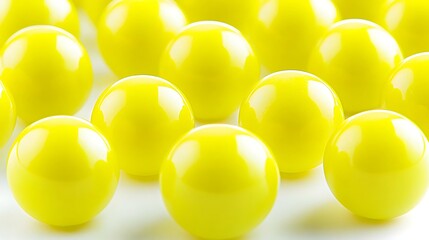 Aufkleber - Close-up view of glossy yellow balls arranged in a pattern on a white surface, creating a vibrant visual effect