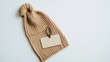 © Tika - Knitted beanie hat with blank tag on white background for design