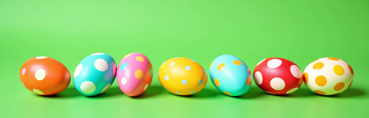 Poster - Colorful Easter Eggs With Various Patterns Are Arranged On A Vibrant Green Background Creating A Visually Appealing Scene.