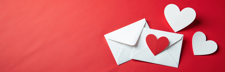 Poster - White Envelopes With Heart Designs On A Red Background Symbolize Love And Romance, Perfect For Conveying Affection And Celebrating Special Occasions.