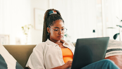 Poster - Laptop, thinking and black woman typing on sofa, living room and search on social media. Computer, student and African person or writing email, research or online browsing on couch for university