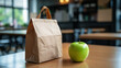 © Olga - Brown paper lunch bag with green apple on wooden table