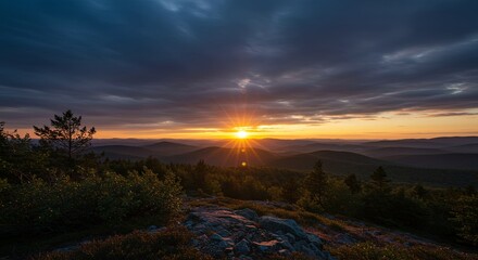 Poster - A beautiful sunset over a mountain range with a bright sun in the sky