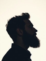 Poster - Silhouette of a bearded man with fade effect against a clean white background capturing a moment of reflection and tranquility