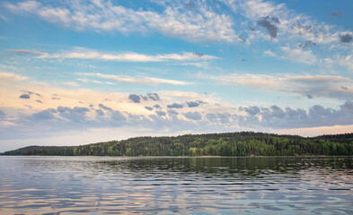 Wall Mural - a calm lake with a cloudy sky in the background