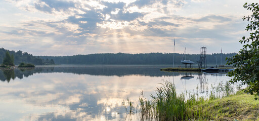 Wall Mural - a lake with a boat dock in the foreground