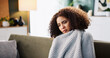 © peopleimages.com - Tired, sick and blanket with woman on sofa for medical recovery, illness and flu season. Disease, fatigue and fever with female person in living room at home for virus outbreak, infection and cold