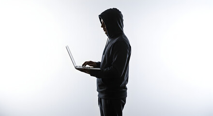 Poster - Silhouette of Person Wearing Hoodie Using Laptop on White Background Cybercrime