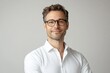 © Agri - A portrait of a smiling man wearing glasses and a white shirt