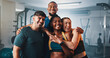 © peopleimages.com - Fitness. portrait and group of friends in gym with smile, support and team workout together. Men, women and happy personal trainer at sports club for exercise, body building and diversity in class