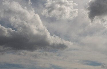 Wall Mural - blue sky with fluffy white close up clouds.
