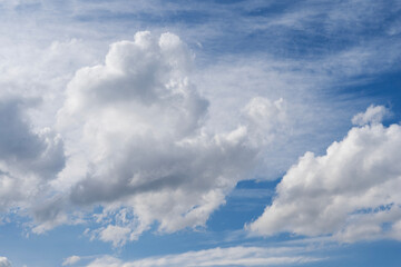 Wall Mural - blue sky with fluffy white close up clouds.