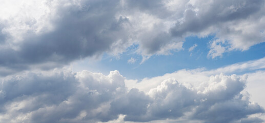 Wall Mural - blue sky with fluffy white close up clouds.