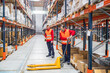 © Koldo_Studio - Warehouse workers moving goods on pallet jack in large distribution center, ensuring efficient product handling and timely delivery