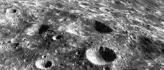 A close-up of the moon's surface showcasing craters and textures