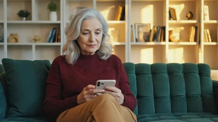 Poster - A person is sitting on a couch and using a cell phone.