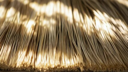 Poster - A close-up view of a bundle of dry straw sitting on a table.