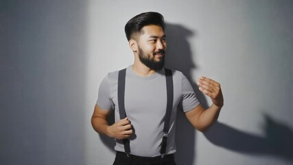 Poster - A man with a beard wearing suspenders and a t-shirt, possibly for a casual occasion or work.