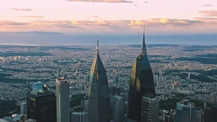 Poster - The skyline features prominent skyscrapers reaching towards the colorful evening sky, symbolizing urban growth and modern architecture in the city.