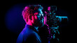 © Sujito - Male Photographer Profile with Camera Equipment and Colorful Illumination in Dark Background