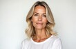 © miss irine - Attractive mature woman looks directly at camera. Middle age beauty portrait of blonde female with elegant, healthy skin. Happy, confident, natural look. Healthy lifestyle and anti-aging concept.