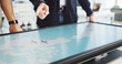 © DavidL2000/peopleimages.com - Energy, people or hands with map on screen for turbine location, wind farm layout or renewable power. Interactive display, teamwork or engineer pointing to chart for speed direction or site selection