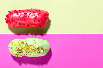 Wall Mural - delicious glazed eclairs on color background