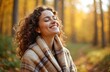 © miss irine - Attractive young woman smiling, breathing fresh autumn air. Calm girl enjoying sunny day in forest, eyes closed. Peaceful, joyful portrait of a happy female. Wellness, healthy lifestyle in nature.
