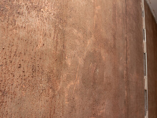 Poster - A wall with a brownish color and a rough texture