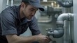 © ArpPSIqee - Plumber inspecting drainage system in basement. Featuring focus and detail