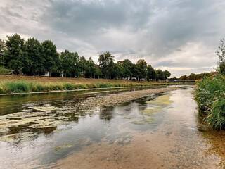 Wall Mural - river with a cloudy sky in the background