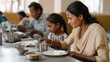 © forenna - Family enjoying a meal at a community kitchen during a warm evening