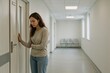 © OlgaNeuroArt - Woman expressing concern while waiting in a hospital corridor