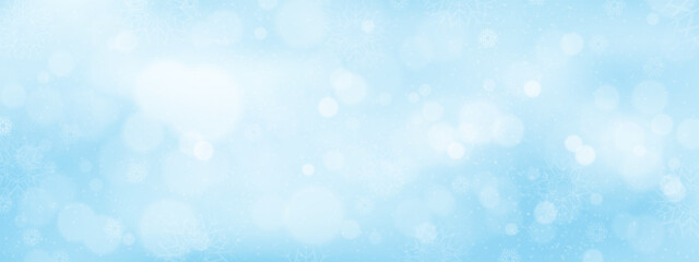 Wall Mural - winter background with soft blue gradient with snow flakes and blurry bokeh light effect,concept for