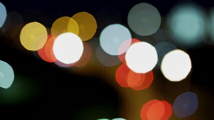 Poster - Vibrant city nightscape featuring blurred, colorful lights creating mesmerizing bokeh effect, transforming urban environment into magical, glowing panorama with shimmering illumination