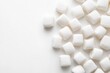 © Aira - White square marshmallows scattered on white surface
