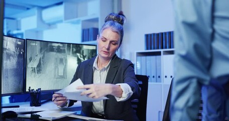 Poster - Women, security guard and documents at office by monitor for review, planning or surveillance strategy. People, paperwork and mentor with feedback in discussion, advice and notes for safety services
